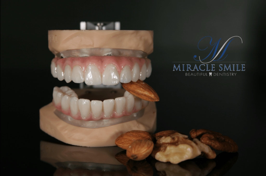 Artificial Dental Teeth Biting Almonds and Walnuts